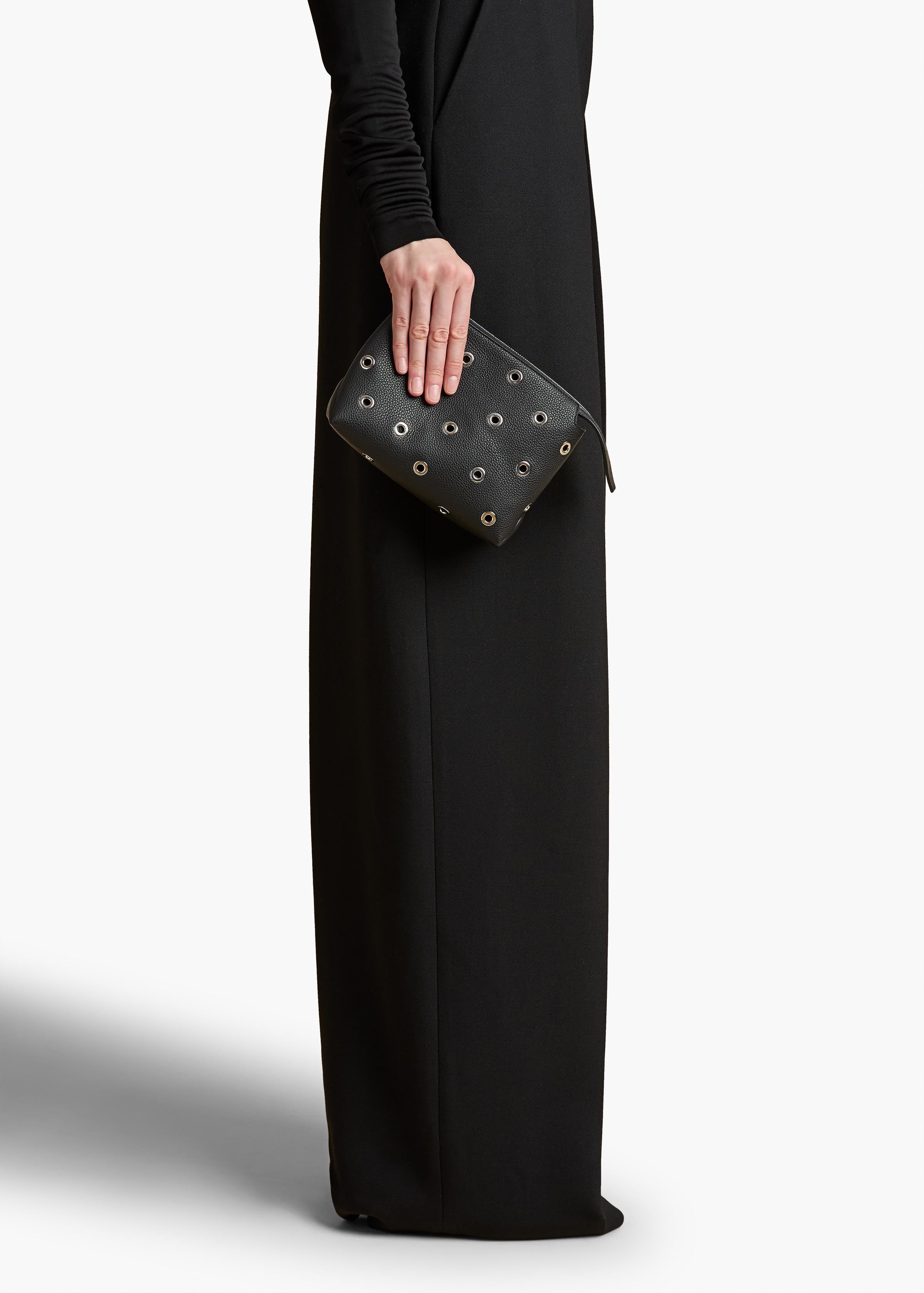 Lina Pochette in Black Pebbled Leather with Grommets ON FIGURE