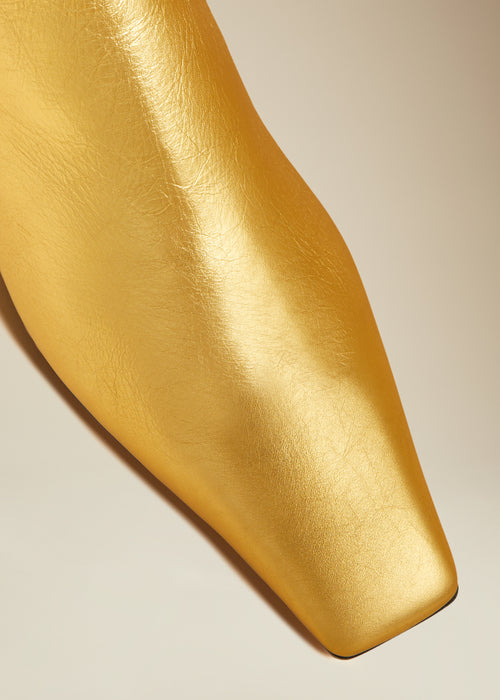 The Marfa Over-the-Knee Flat Boot in Gold Metallic Leather